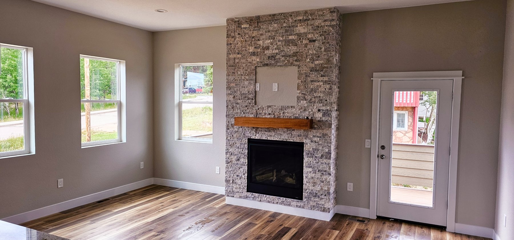 Great room with fireplace and deck door