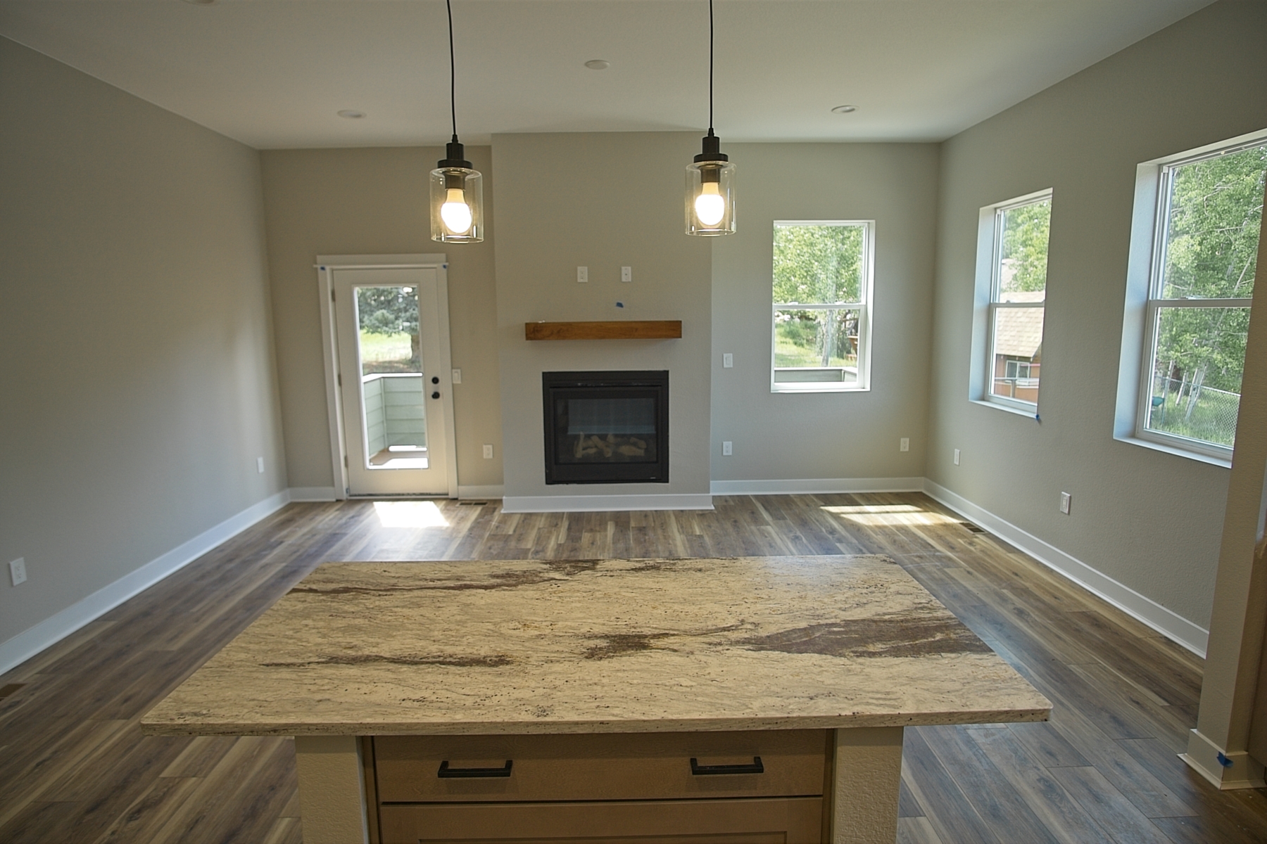 Great room and fireplace with deck view of 312 Spruce Meadow Grove