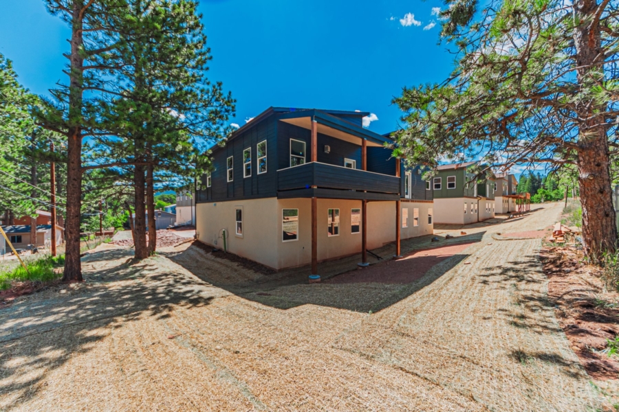 Exterior view of 320 Spruce Meadow Grove with yard and deck area